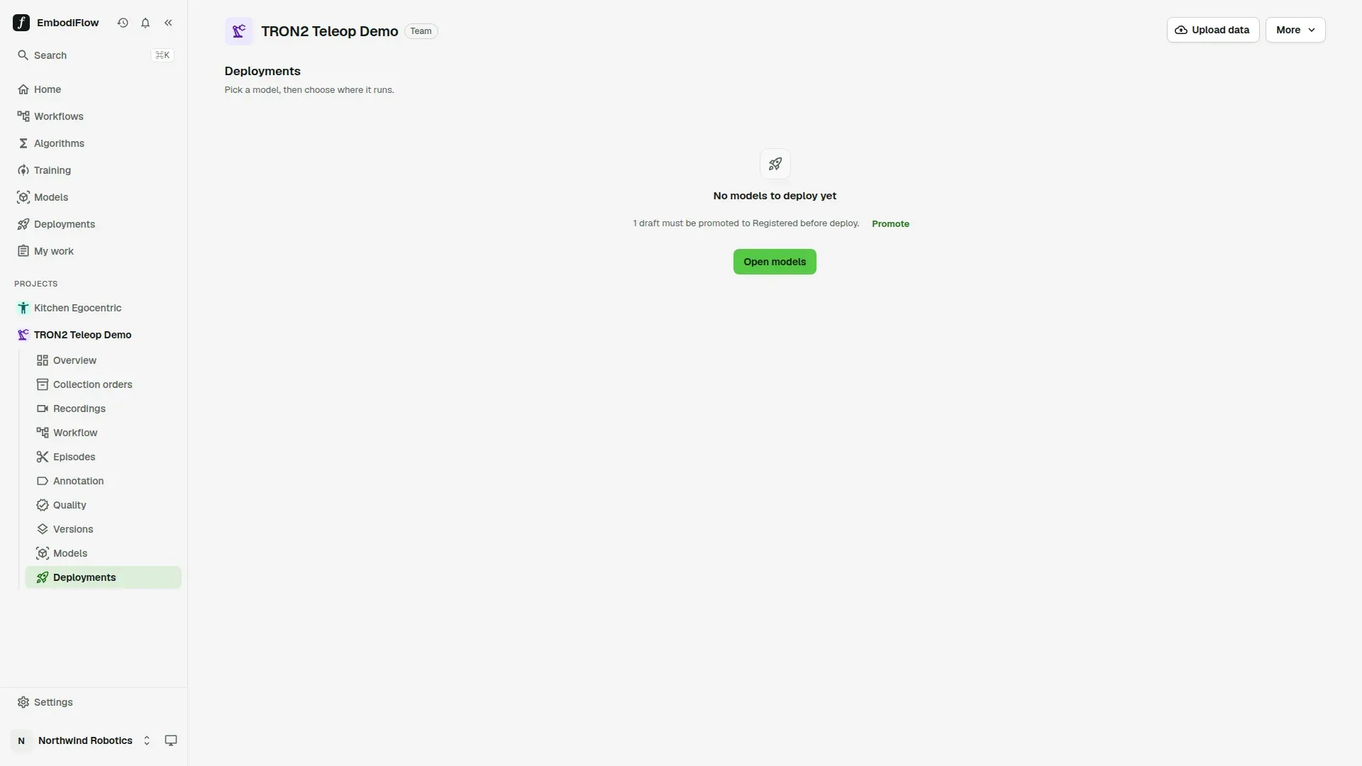 The Deployments page inside a project, with the line Pick a model, then choose where it runs, and the empty message No models to deploy yet, which says 1 draft must be promoted to Registered before deploy, with a Promote link and an Open models button
